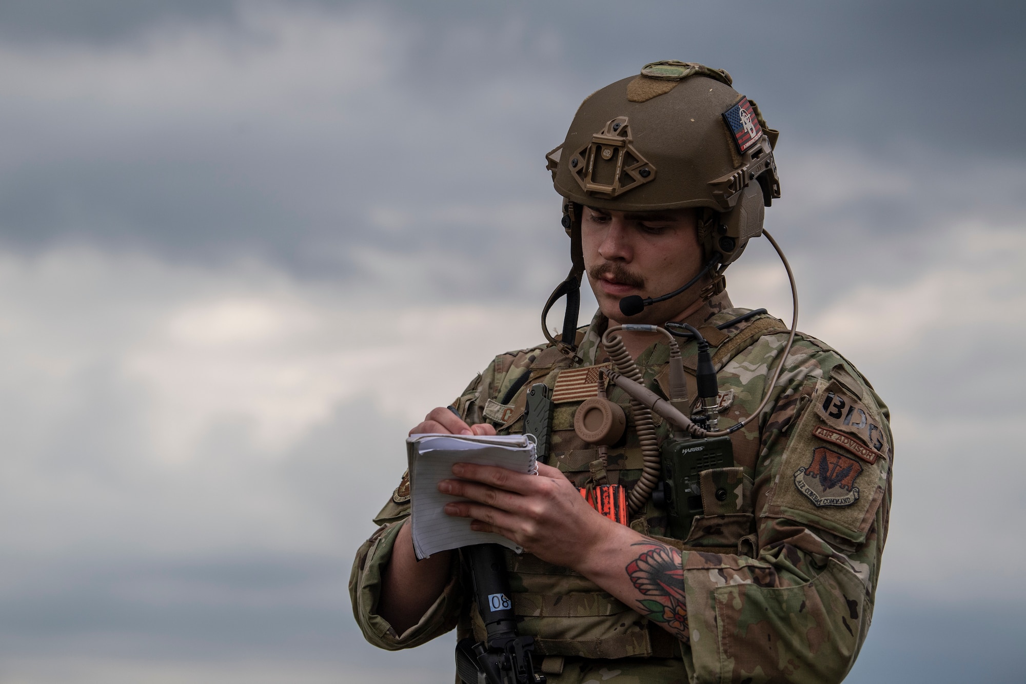U.S. Air Force Senior Airman Peyton Collins, 822nd Base Defense Squadron squad system operator, takes notes