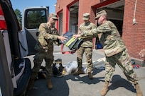 Staff Sgt. James Maltais, Sgt. Patrick McLaughlin and Pfc. John Jones of the 26th Maneuver Enhancement Brigade, Massachusetts National Guard, visit the Milton Fire Department in Milton, Massachusetts. to collect fire-retardant gear donated to the Military Division of the Commonwealth of Massachusetts.  This gear was shipped to fire departments in Paraguay, a partner with the Massachusetts National Guard under the State Partnership Program.
