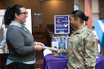 Dr. Diaz discusses the importance of mental fitness with Army Pvt. 2 Kaliyah Rowan at the Mental Fitness Information table during Staff Resiliency Week at Walter Reed. Diaz says prioritizing mental health is key to building resilience, and shared five ways staff members can do just that in honor of Mental Health Awareness Month: Being aware, taking advantage of resources, asking for help, practicing self-care and building a support system.