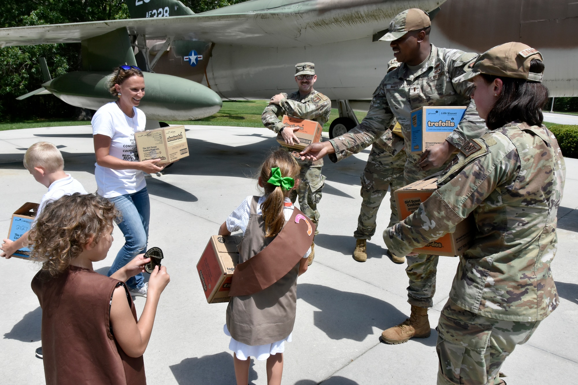 2nd Lt. Reginald Maffett shows one of the Arnold Engineering Development Complex patches given to visiting Girl Scouts May 17, 2023. Tullahoma Girl Scouts from Troop 2127 visited the AEDC headquarters at Arnold Air Force Base, Tenn., to deliver cookies to Arnold service members to show appreciation for their service. Members of the Arnold AFB Company Grade Officers’ Council accepted the cookies to distribute them to fellow military members on base. (U.S. Air Force photo by Bradley Hicks)