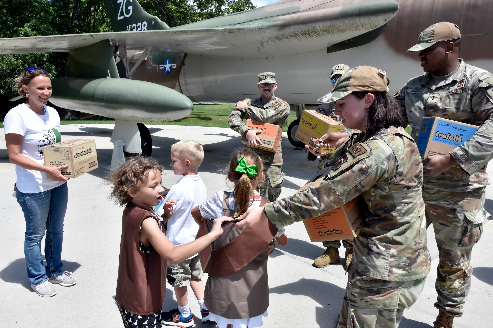 1st Lt. Camden Dammeyer gives local Girl Scout Aria Lopez an Arnold Engineering Development Complex patch May 17, 2023. Tullahoma Girl Scouts from Troop 2127 visited the AEDC headquarters at Arnold Air Force Base, Tenn., to deliver cookies to Arnold service members to show appreciation for their service. Members of the Arnold AFB Company Grade Officers’ Council accepted the cookies to distribute them to fellow military members on base. (U.S. Air Force photo by Bradley Hicks)