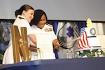 Navy Capt. Jessica Beard (right), chief nursing officer and director of nursing at Walter Reed National Military Medical Center, and Ensign Renee Boudreau, as the most senior and junior members of the corps respectively at WRNMMC, cut the 115th Navy Nurse birthday on May 12.