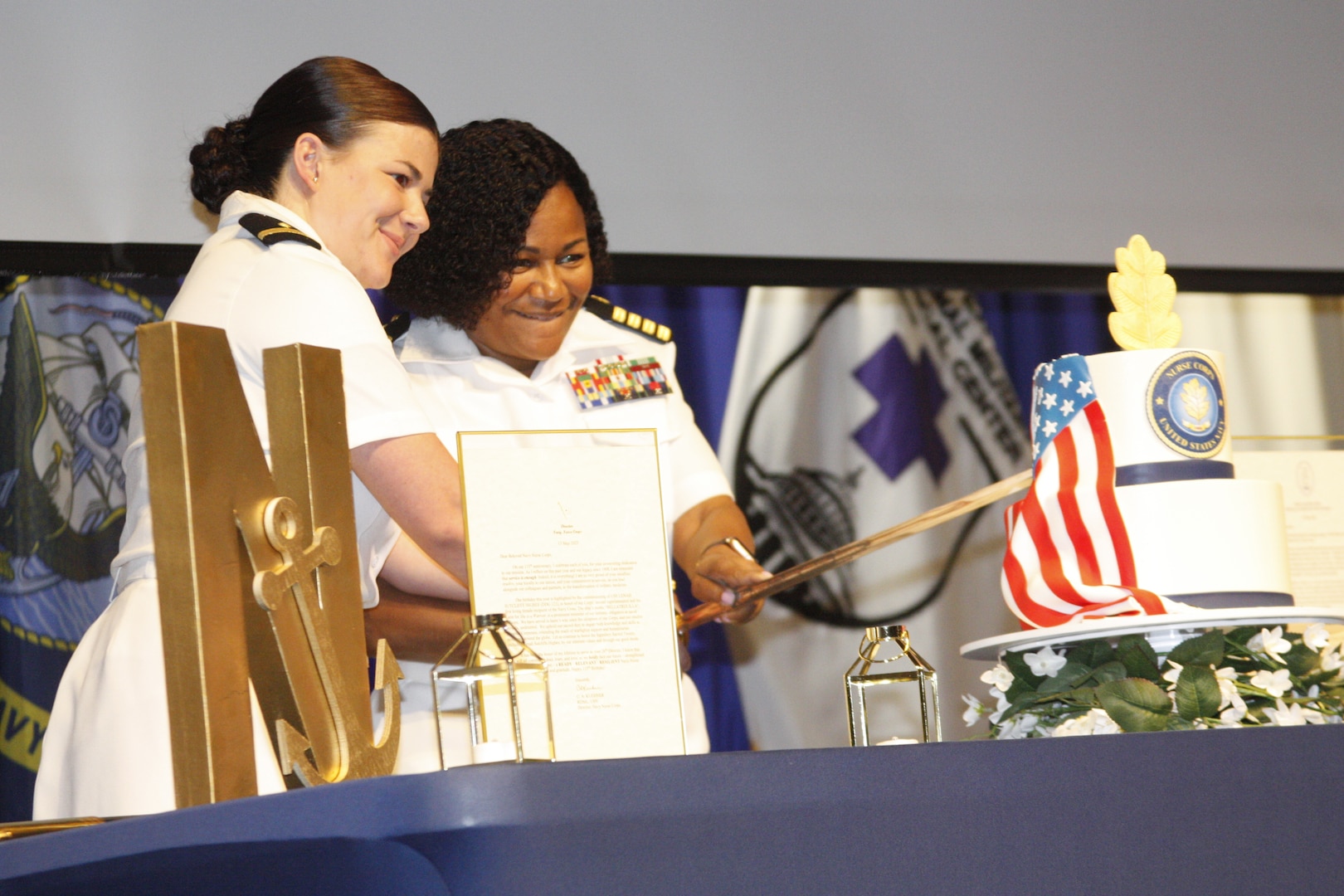 Navy Capt. Jessica Beard (right), chief nursing officer and director of nursing at Walter Reed National Military Medical Center, and Ensign Renee Boudreau, as the most senior and junior members of the corps respectively at WRNMMC, cut the 115th Navy Nurse birthday on May 12.