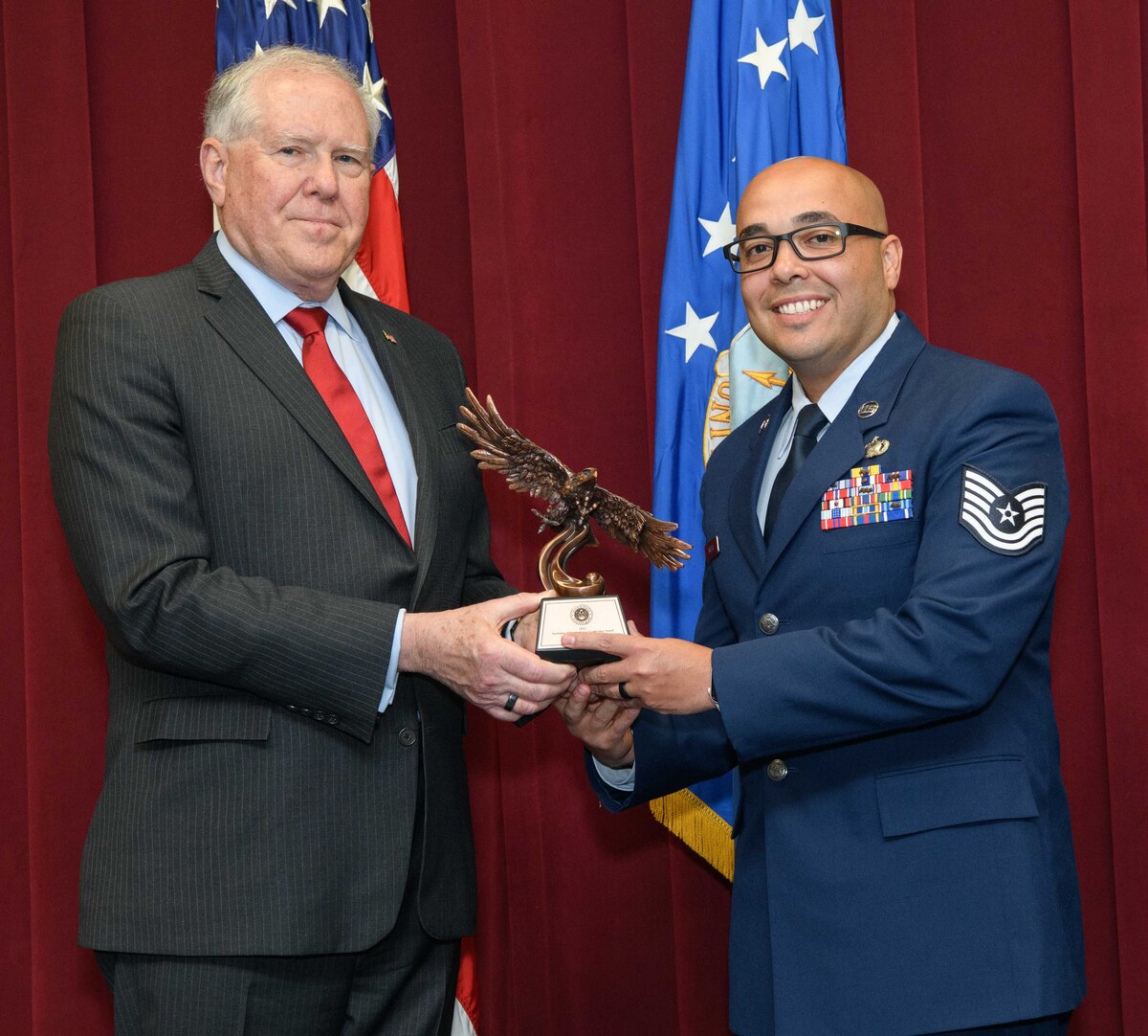 Secretary of the Air Force Frank Kendall presents a Secretary of the Air Force 2022 Leadership Award to Tech. Sgt. Jose Rivera