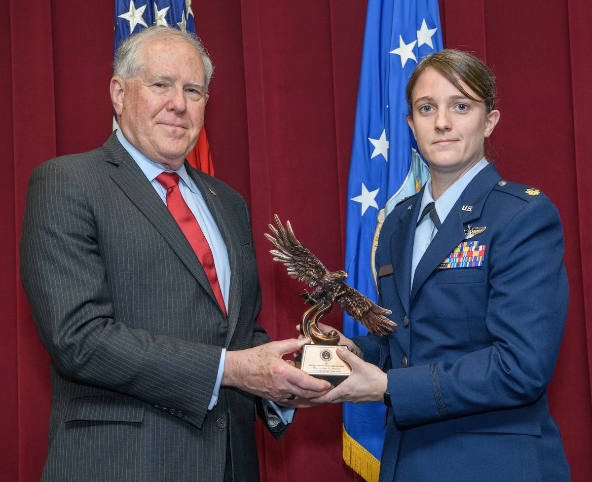 Secretary of the Air Force Frank Kendall presents a Secretary of the Air Force 2022 Leadership Award to Maj. Kelsey Payton