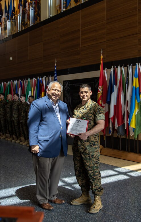 The Secretary of the Navy, the Honorable Mr. Carlos Del Toro, stands with Marine Security Guard Detachment Commander, Staff Sgt. Derek Ferrari, after awarding him the Navy and Marine Corps Commendation Medal at Marine Corps Embassy Security Group Headquarters in Quantico, Va., May 19, 2023. Ferrari was awarded for his actions during the evacuation of the U.S. Embassy in Khartoum, Sudan. (U.S. Marine Corps photo by Sgt. Braden Hale)