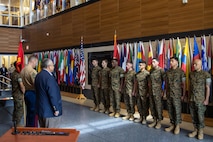 The Secretary of the Navy, the Honorable Mr. Carlos Del Toro, prepares to award the Navy and Marine Corps Achievement Medal to 11 Marine Security Guards at Marine Corps Embassy Security Group Headquarters in Quantico, Va., May 19, 2023. The Marines were awarded for their actions during the evacuation of the U.S. Embassy in Khartoum, Sudan. (U.S. Marine Corps photo by Sgt. Braden Hale)