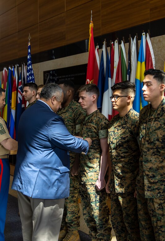 The Secretary of the Navy, the Honorable Mr. Carlos Del Toro, presents the Navy and Marine Corps Achievement Medal to 11 Marine Security Guards at Marine Corps Embassy Security Group Headquarters in Quantico, Va., May 19, 2023. The Marines were awarded for their actions during the evacuation of the U.S. Embassy in Khartoum, Sudan. (U.S. Marine Corps photo by Sgt. Braden Hale)