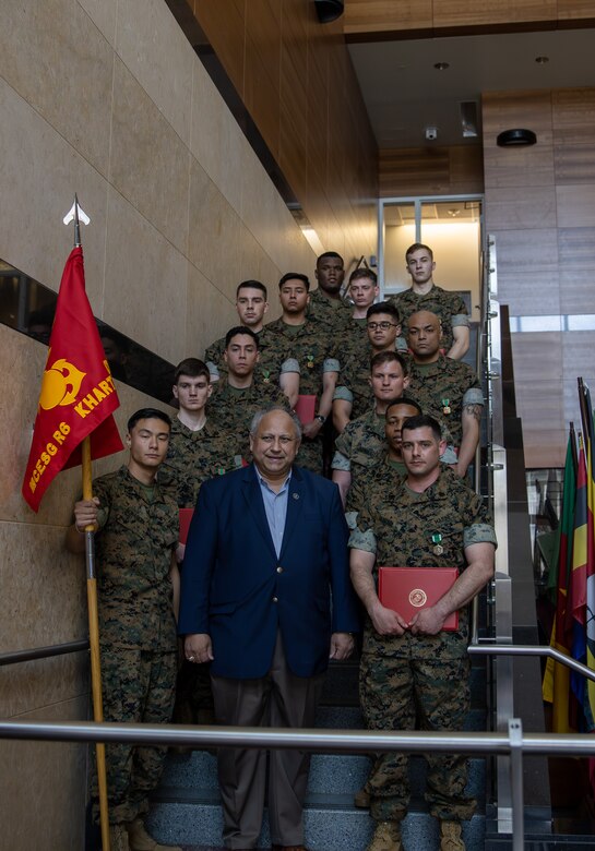 The Secretary of the Navy, the Honorable Mr. Carlos Del Toro, stands with 13 Marine Security Guards at Marine Corps Embassy Security Group Headquarters in Quantico, Va., May 19, 2023. Del Toro awarded the 12 Marines with Detachment Khartoum for their efforts in safely evacuating 75 embassy personnel from the U.S. Embassy in Khartoum amid surging conflict in Sudan. (U.S. Marine Corps photo by Sgt. Braden Hale)