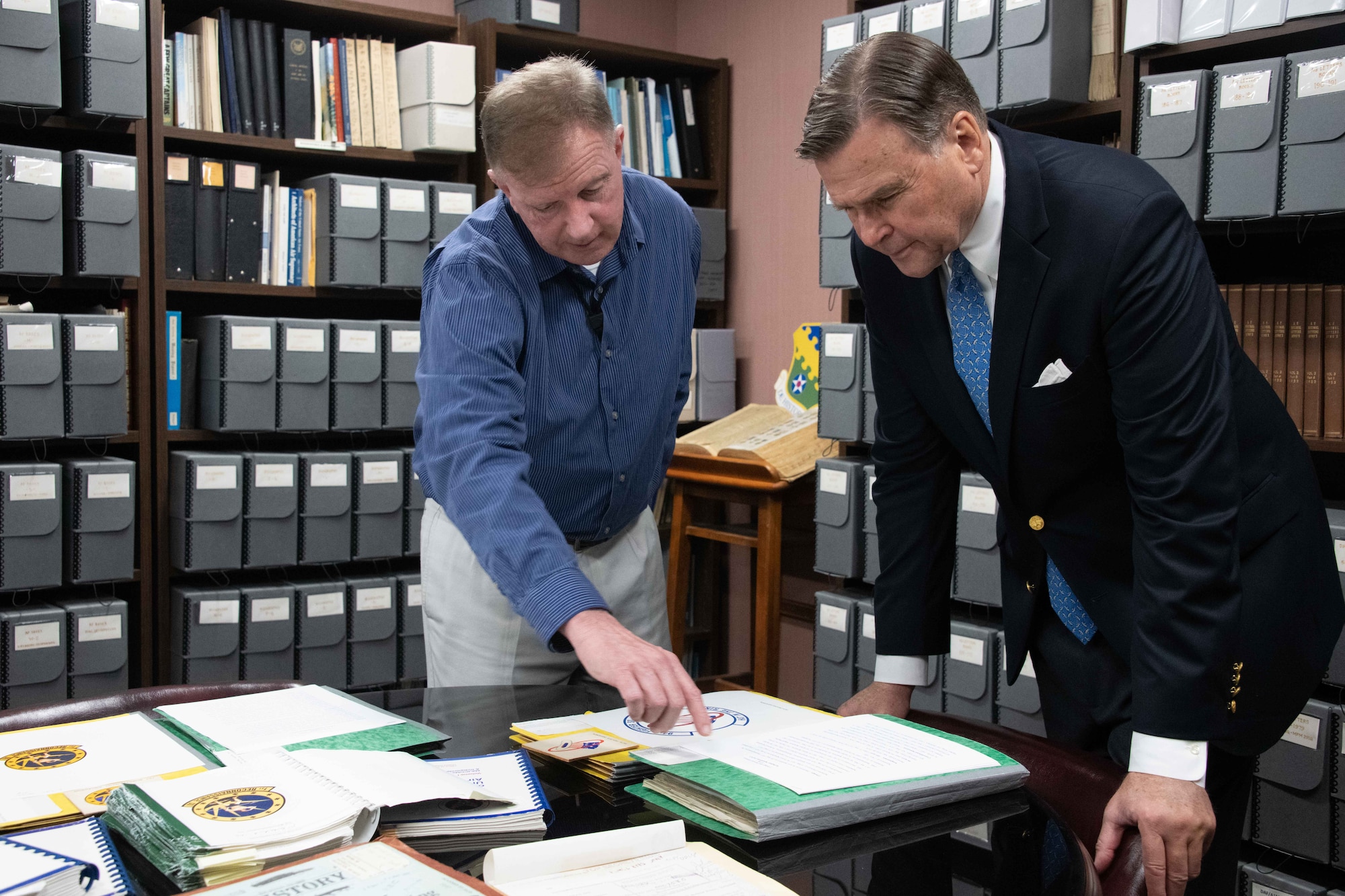 Sam Shearin, Air Force Historical Research Agency heraldry lead, briefs Ambassador (retired) W. Stuart Symington on the Air Force Heraldry file system at Maxwell Air Force Base, Ala.