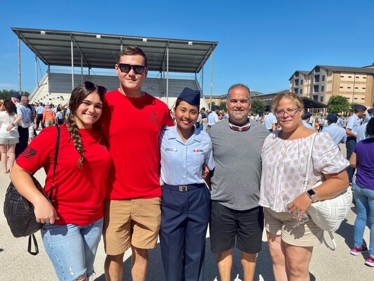 Rivera, center, poses with Yan, second to the left, and his family ahead of Rivera's Basic Military Training graduation ceremony.