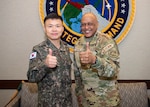 Maj Gen Park Hu Soung, the director of the Republic of Korea Joint Chiefs of Staff's Countering Weapons of Mass Destruction (CWMD) directorate, and U.S. Air Force Gen. Anthony Cotton, the commander of U.S. Strategic Command (USSTRATCOM), give the camera a thumbs up.