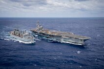 The Nimitz-class aircraft carrier USS George H.W. Bush (CVN 77) is underway alongside the fast combat support ship USNS Supply (T-AOE 6).