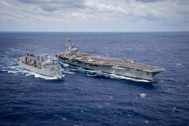 The Nimitz-class aircraft carrier USS George H.W. Bush (CVN 77) is underway alongside the fast combat support ship USNS Supply (T-AOE 6).