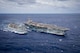 The Nimitz-class aircraft carrier USS George H.W. Bush (CVN 77) is underway alongside the fast combat support ship USNS Supply (T-AOE 6).