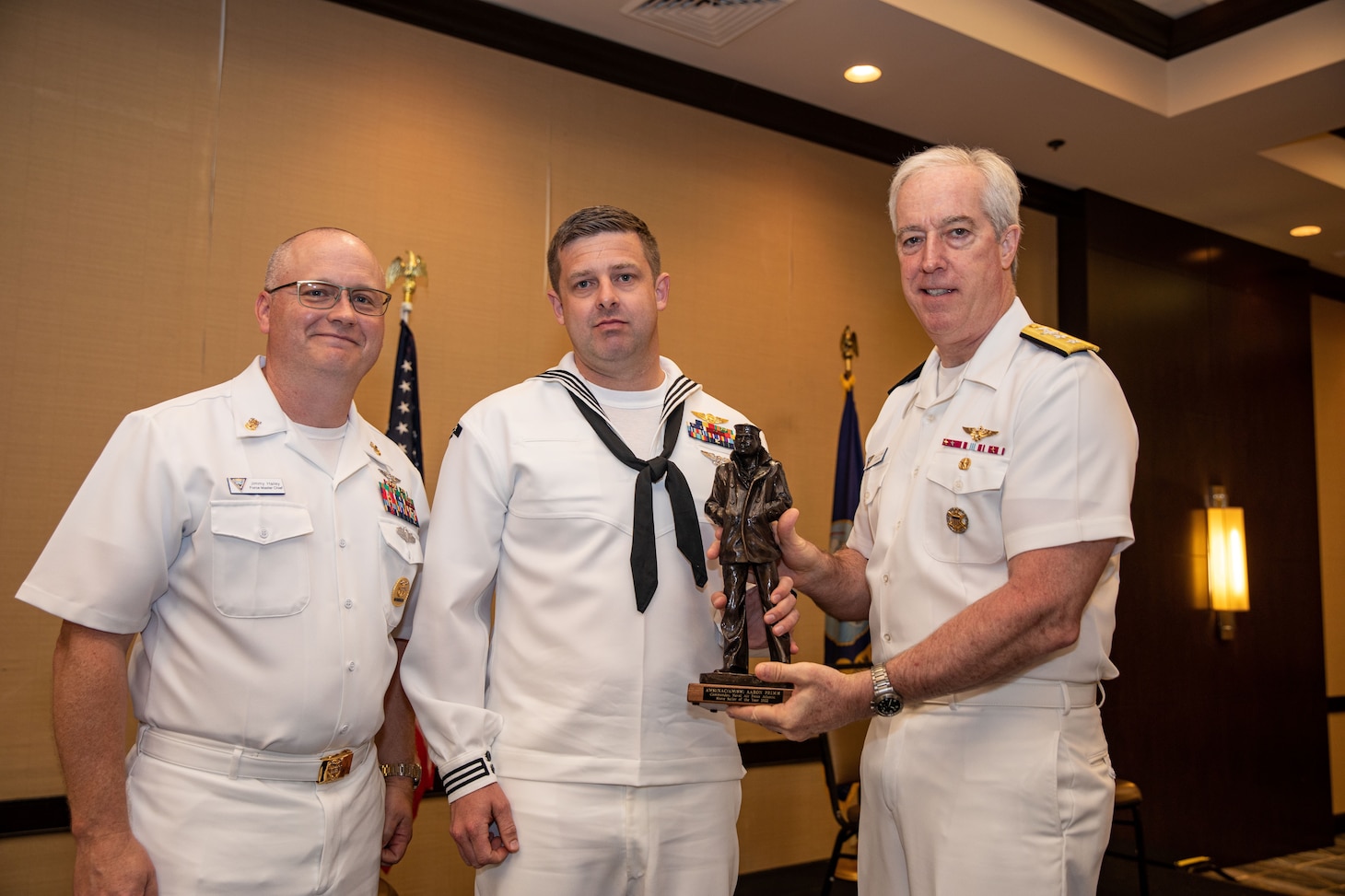 awardee stands with award with CNAL