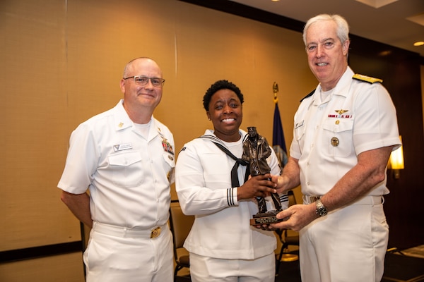 awardee poses with award with CNAL