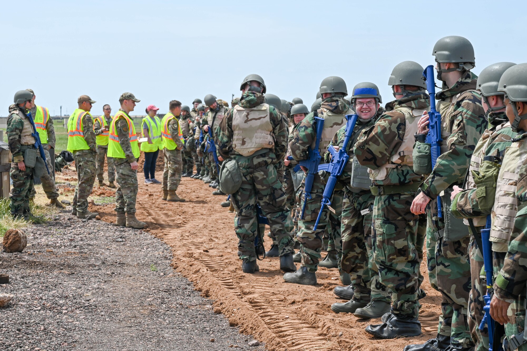 Airmen from the 97th Air Mobility Wing wait for a Chemical Biological Radiological Nuclear (CBRN) portion of their exercise to begin at Altus Air Force Base, Oklahoma, May 2, 2023. The Airmen were shown how to properly don and remove Mission Oriented Protective Posture gear, as well as tarping equipment during a CBRN hazard. (U.S. Air Force photo by Senior Airman Trenton Jancze)