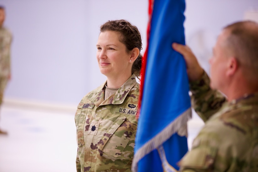 Lt. Col. Tenay Benes, a female Soldier, smiles as she prepares to take the colors from the brigade commander.