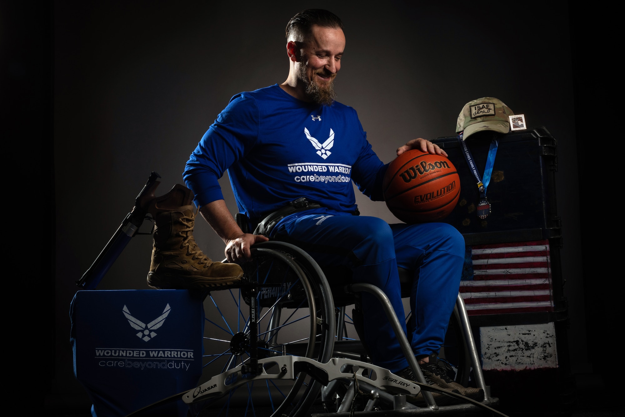 James Phelps, a prior U.S. Air Force technical sergeant who has four Afghanistan deployments, sits in his wheelchair surrounded by wounded warrior sports memorabilia at Joint Base Elmendorf-Richardson, Alaska, May 17, 2023. Phelps spent most of his career as an integrated avionics craftsman with the 211th and 212th Rescue squadrons and said the strain of war, combat deployments, Post-traumatic Stress Disorder and the suicide of his best friend brought him to a low point in his life. His wife, the Fisher House Foundation and the Warrior Games intervened. "I met some amazing souls as I let go of the shame I held for not having reached 20 active-duty years," Phelps said. "I learned compassion, which allowed me to let go of resentment in regards to my military service. Most impressively, we started to heal.” He continues to compete in the Wounded Warrior Games and strongly advocates for struggling service members to reach out for help. "You are not alone," he said. (U.S. Air Force photo by Justin Connaher)
