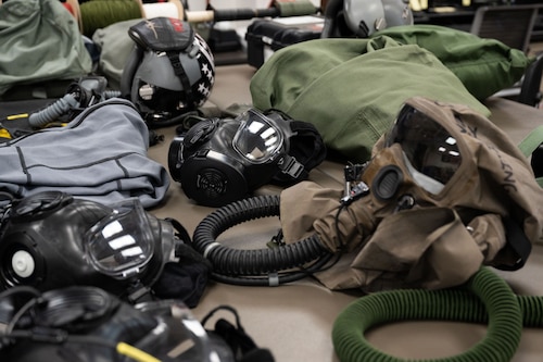 A modified M-50 ground crew mask as well as other Chemical, Biological, Radiological, and Nuclear (CBRN) protective gear is on display during training related to the Step-Launch and Recover concept of operation, Joint Base Pearl Harbor-Hickam, Hawaii, May 10, 2023. Over the past few years, there has been a slew of innovative ideas that have been brought to the Pacific Air Forces region—the most recent being the U.S. Air Force Next Generation Aircrew Protection project. This allows aircrew to safely generate sorties in a CBRN contaminated environment. (U.S. Air Force photo by Tech. Sgt. Hailey Haux)