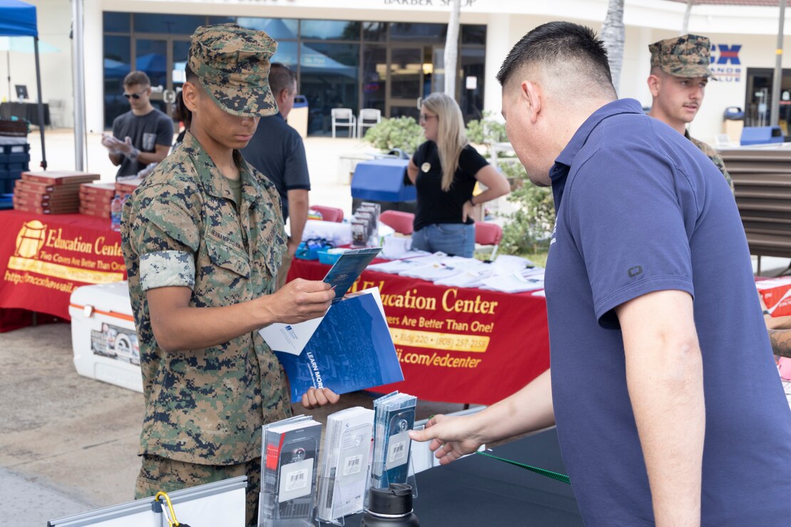 U.S. Marine Corps Pfc. Johnathan Hernandezcervantes, motor transport vehicle operator, Combat Logistics Battalion 3, views a flyer during the Spring Into Your Education Fair, Marine Corps Base Hawaii, May 17, 2023. The fair offered service members and civilians a chance to learn more about educational benefits in the military while also being able to meet college representatives from around the country. (U.S. Marine Corps photo by Cpl. Chandler Stacy)