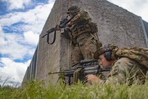 U.S. Army soldiers with Bravo Company, 2nd Battalion, 35th Infantry Regiment, 3rd Infantry Brigade Combat Team, 25th Infantry Division, hold security during urban operations training at Pyramid Rock Beach, Marine Corps Base Hawaii, May 12, 2023. Scout swimmers with Comanche Troop, 3rd Squadron, 4th Cavalry Regiment, 3rd Infantry Brigade Combat Team, 25th Infantry Division, transported three platoons with Bravo Company, 2nd Battalion, 35th Infantry Regiment, 3rd Infantry Brigade Combat Team, 25th Infantry Division, and secured a beach landing site in order to insert a raid force to ensure the units are ready to conduct a full spectrum of waterborne operations. (U.S. Marine Corps photo by Sgt. Julian Elliott-Drouin)