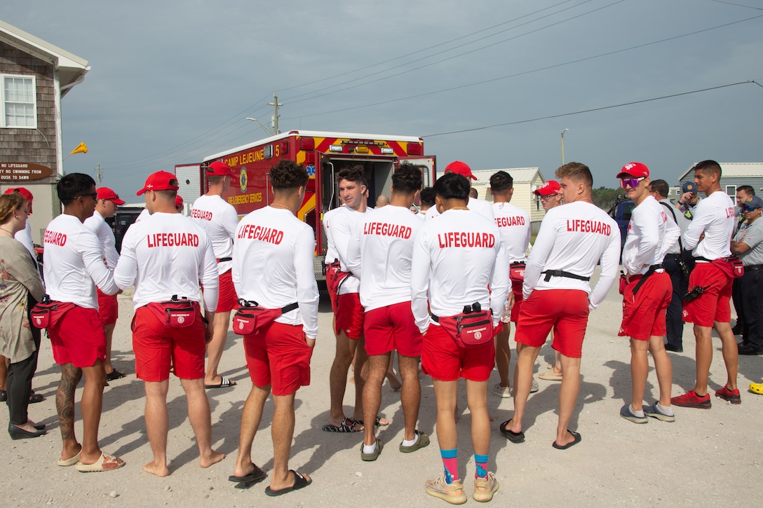U.S. Marine Corps lifeguards with the Onslow Beach Detachment gather for a demonstration of ambulance capabilities before a training exercise on Onslow Beach, Marine Corps Base Camp Lejeune, North Carolina, May 18, 2023.  Each year training is conducted to familiarize the Beach Detachment, first responders, and other individuals with the expectations of response in case of an emergency. (U.S. Marine Corps photo by Cpl. Zeta Johnson)