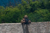 A U.S. Army infantryman with Bravo Company, 2nd Battalion, 35th Infantry Regiment, 3rd Infantry Brigade Combat Team, 25th Infantry Division, provides suppressive fire during Military Operations in Urbanized Terrain training at Pyramid Rock Beach, Marine Corps Base Hawaii, May 16, 2023. The purpose of the exercise was to train to secure a beach landing site in order to insert a raid force to ensure the units are ready to conduct a full spectrum of waterborne operations. (U.S. Marine Corps photo by Lance Cpl. Terry Stennett III)