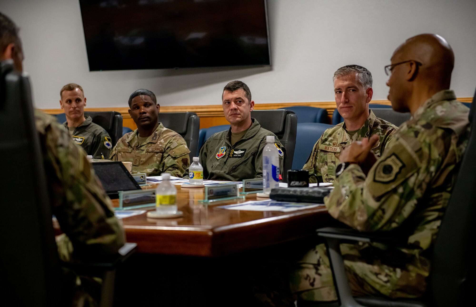 Airmen sit at a table