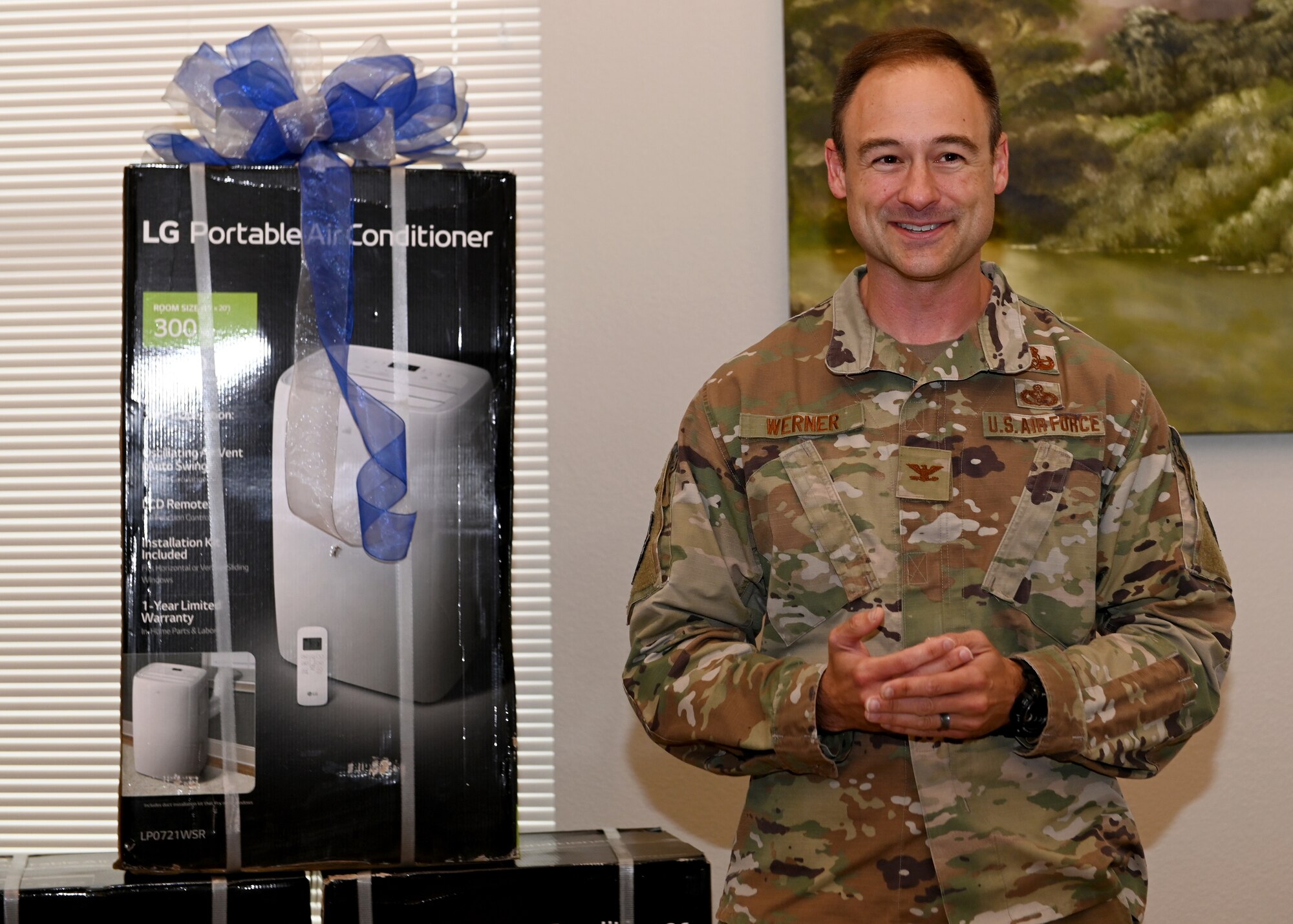 Colonel Daniel Werner, 10th Air Base Wing vice commander, stands in front of three air conditioning units recently donated to the U.S. Air Force Academy as part of quality of life improvements.