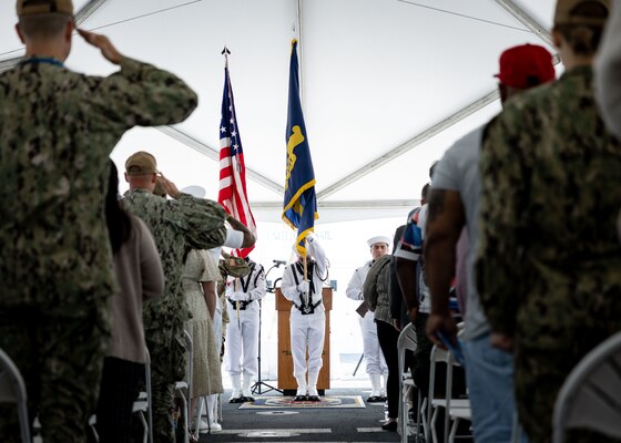 Attendees salute the National Ensign while the USNS Comfort (T-AH 20) Color Guard presents the colors during Military Sealift Command’s National Maritime Day ceremony aboard Comfort May 22, 2023. National Maritime Day honors the thousands of dedicated merchant mariners who served aboard United States vessels around the world.