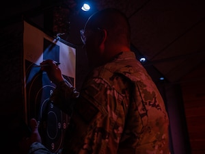 U.S. Air Force Staff Sgt. Nathan Rust, 56th Security Forces Squadron combat arms instructor, writes a score on a target, May 17, 2023, at Luke Air Force Base, Arizona.