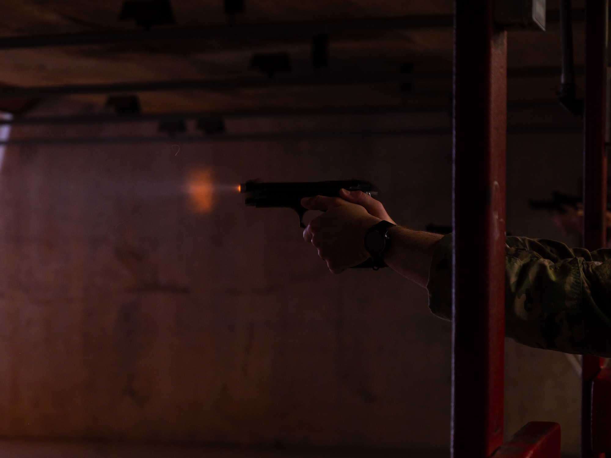 A member of the 56th Security Forces Squadron fires a Baretta M9 handgun, May 17, 2023, at Luke Air Force Base, Arizona.