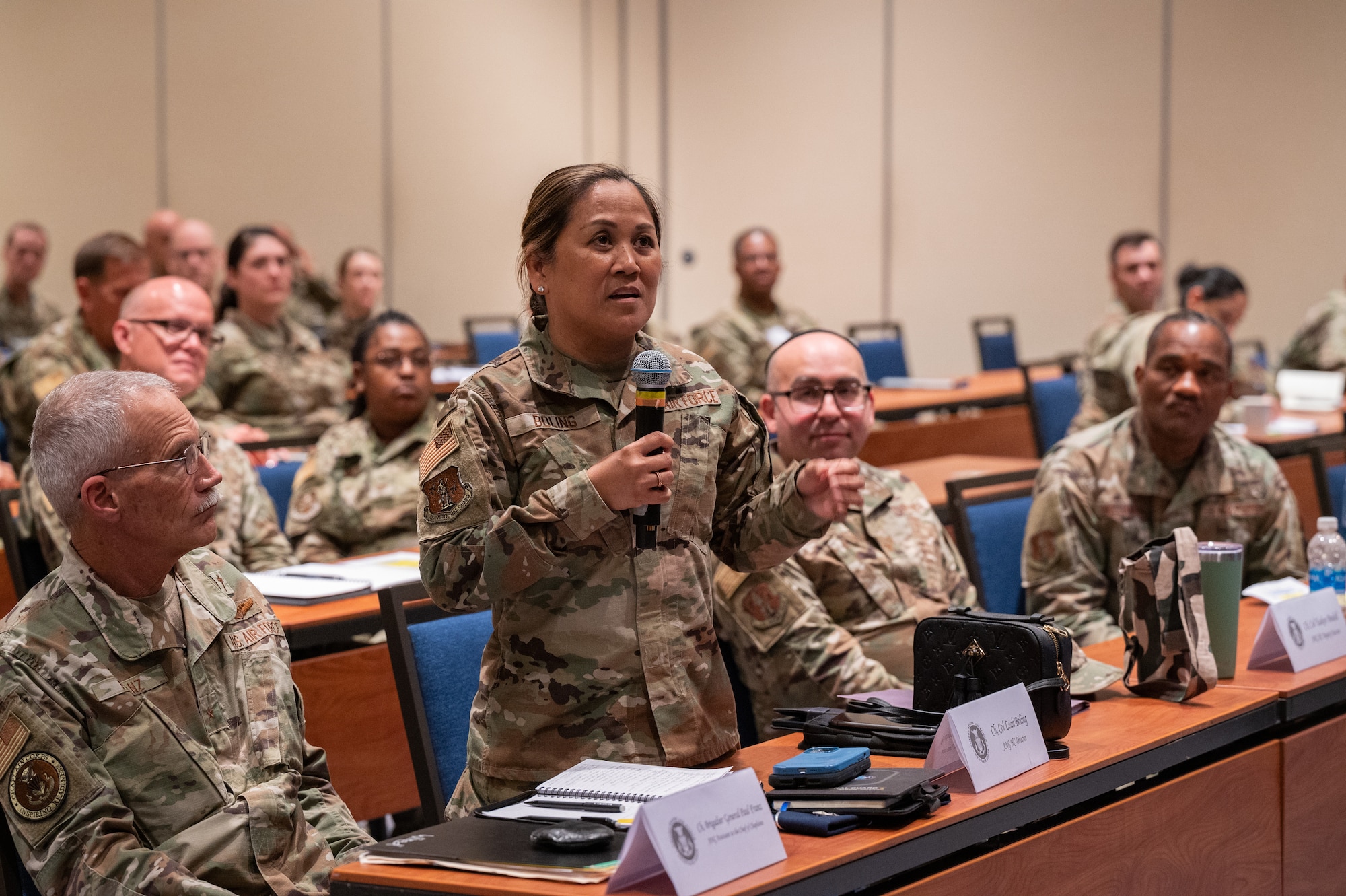 U.S. Air Force Col. Leah Botona Boling, director, Air National Guard (ANG) Chaplain Corps, poses a question for Lt. Gen. Michael A. Loh, director, ANG, during the ANG Chaplain Corps Senior Religious Support Team Symposium in Arlington, Virginia, May 17, 2023.