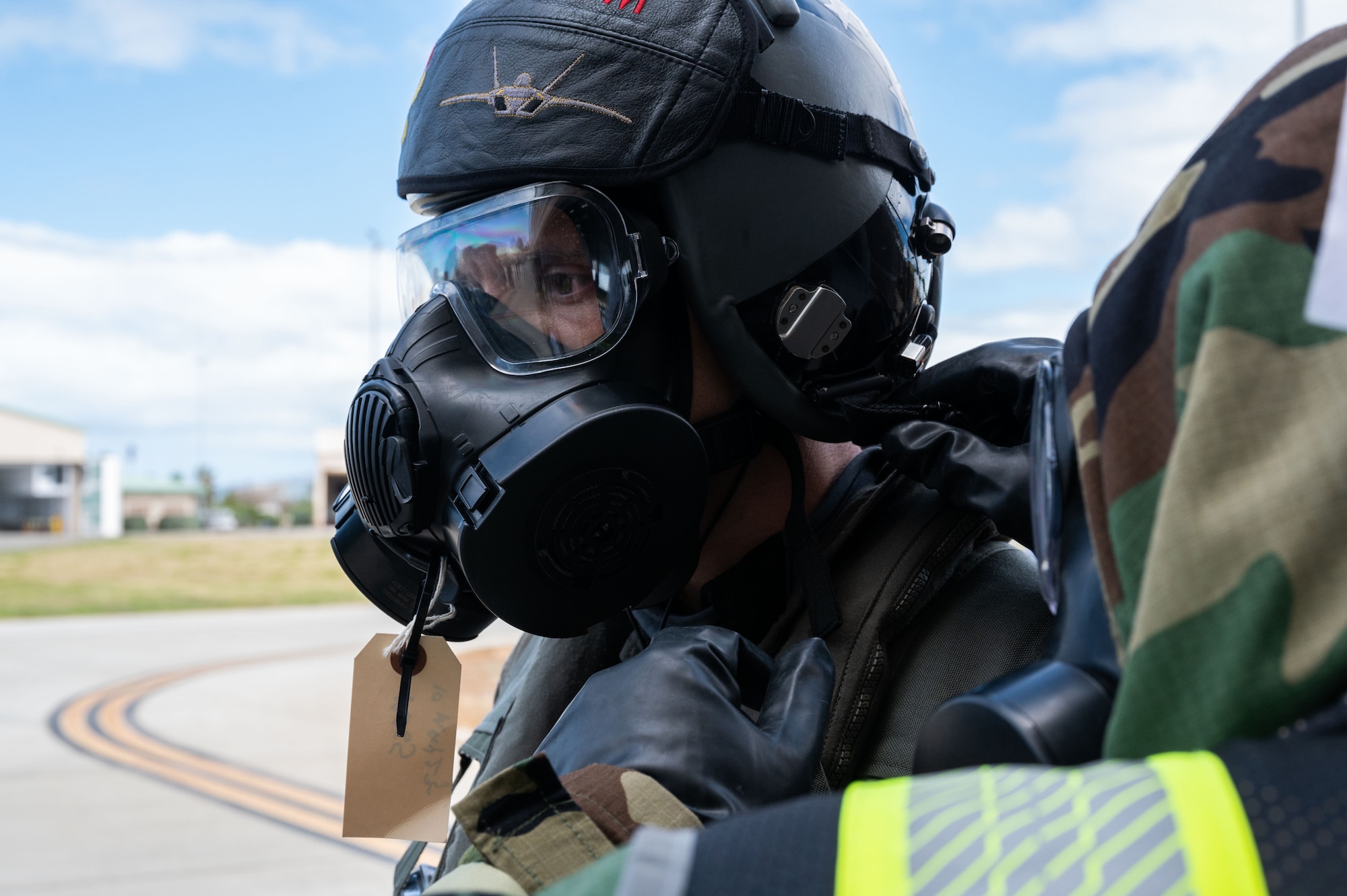 U.S. Air Force Capt. Alex “Doom” Moss, 19th Fighter Squadron F-22 Raptor pilot, utilizes the aircrew ensemble respiratory protection system while processing through the aircrew contamination control area during the Next Generation Aircrew Protection Step- Launch and Recover training event, Joint Base Pearl Harbor-Hickam, Hawaii, May 10, 2023. The events at Hickam were capped off with the opportunity to showcase the successful efforts of all involved to the Commander of Pacific Air Forces, highlighting to him how these practical risk-based decisions are allowing his wing commanders to Fight Tonight. (U.S. Air Force photo by Tech. Sgt. Hailey Haux)