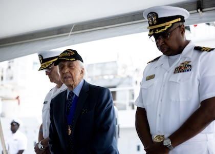 Dave Yoho, U.S. Merchant Marine and World War II Veteran, (center) bows his head for a moment of silence during Military Sealift Command’s National Maritime Day ceremony aboard USNS Comfort (T-AH 20) May 22, 2023. National Maritime Day honors the thousands of dedicated merchant mariners who served aboard United States vessels around the world.