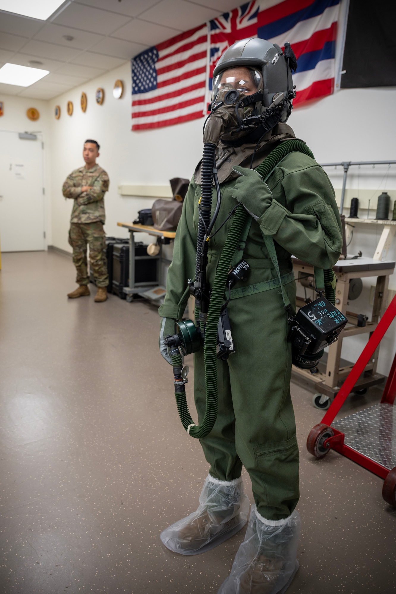 U.S. Air Force Airman Kyla Correos, 15th Operations Support Squadron aircrew flight equipment specialist, models the aircrew ensemble respiratory protection system during a Next Generation Aircrew Protection Step-Launch and Recover concept of operation demonstration, Joint-Base Pearl Harbor-Hickam, Hawaii, May 11, 2023.The demonstration showcases the Pacific Air Forces stop gap for the F-22 Aircrew Chemical, Biological, Radiological and Nuclear limiting factor utilizing the modified M-50 ground crew mask. (U.S. Air National Guard photo by Master Sgt. Mysti Bicoy)