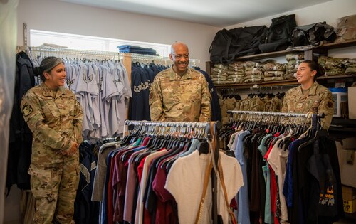 Airmen stand in a room