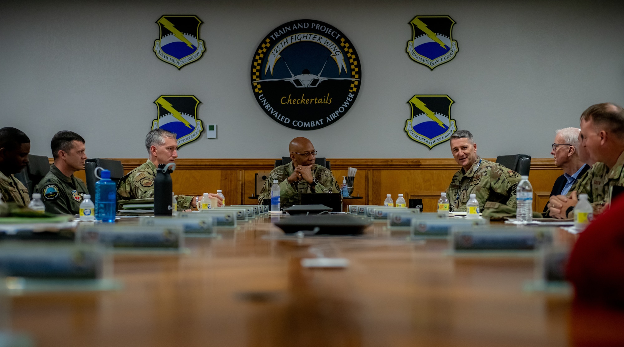 Airmen sit and talk at a table