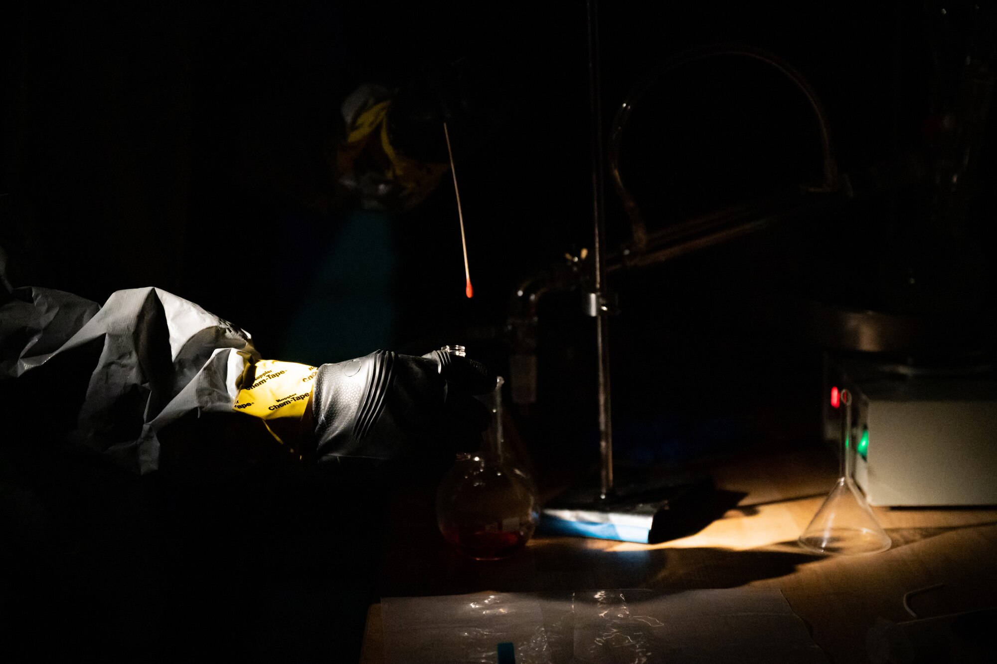 A Soldier samples a liquid.