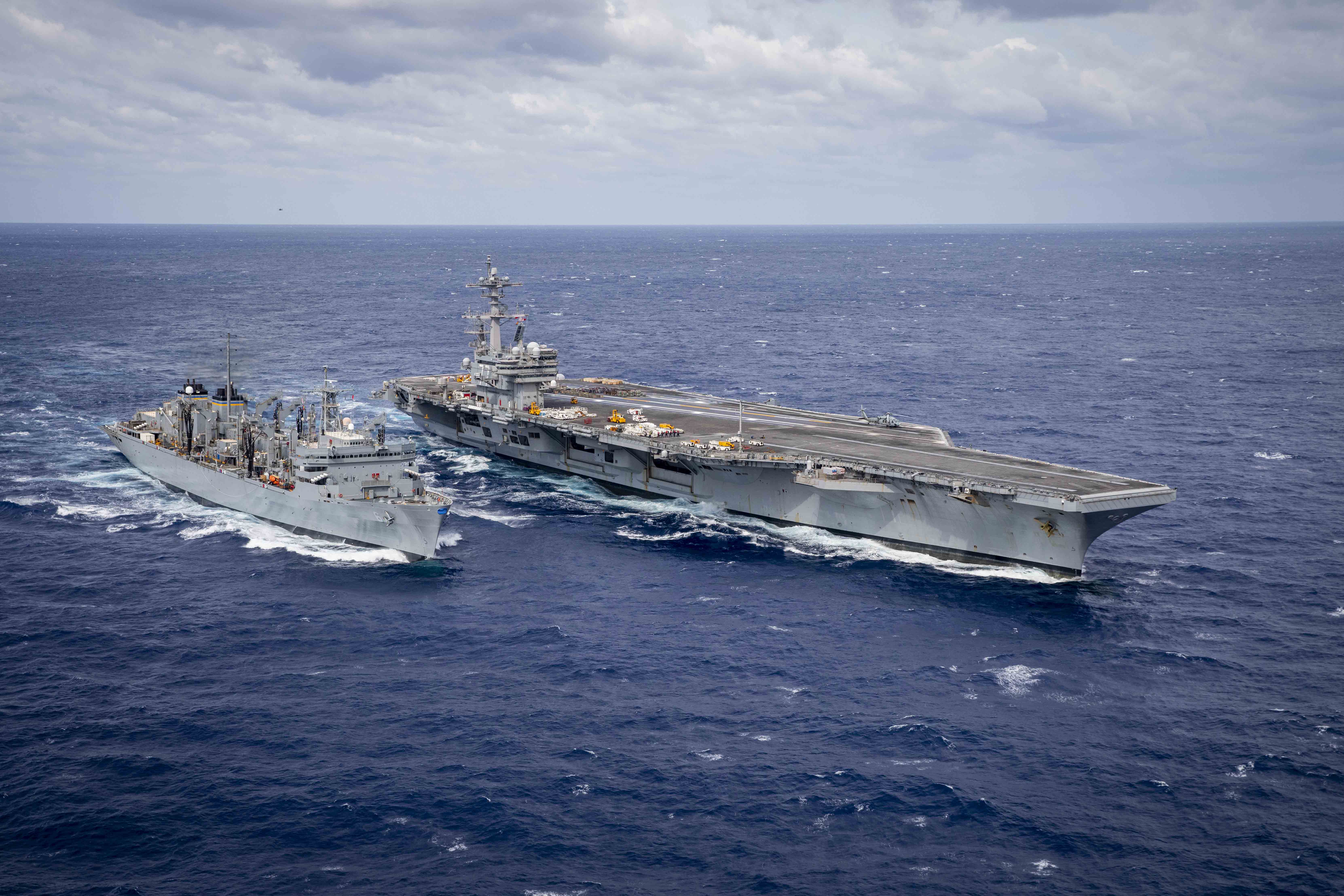 The Nimitz-class aircraft carrier USS George H.W. Bush (CVN 77) is underway alongside the fast combat support ship USNS Supply (T-AOE 6).