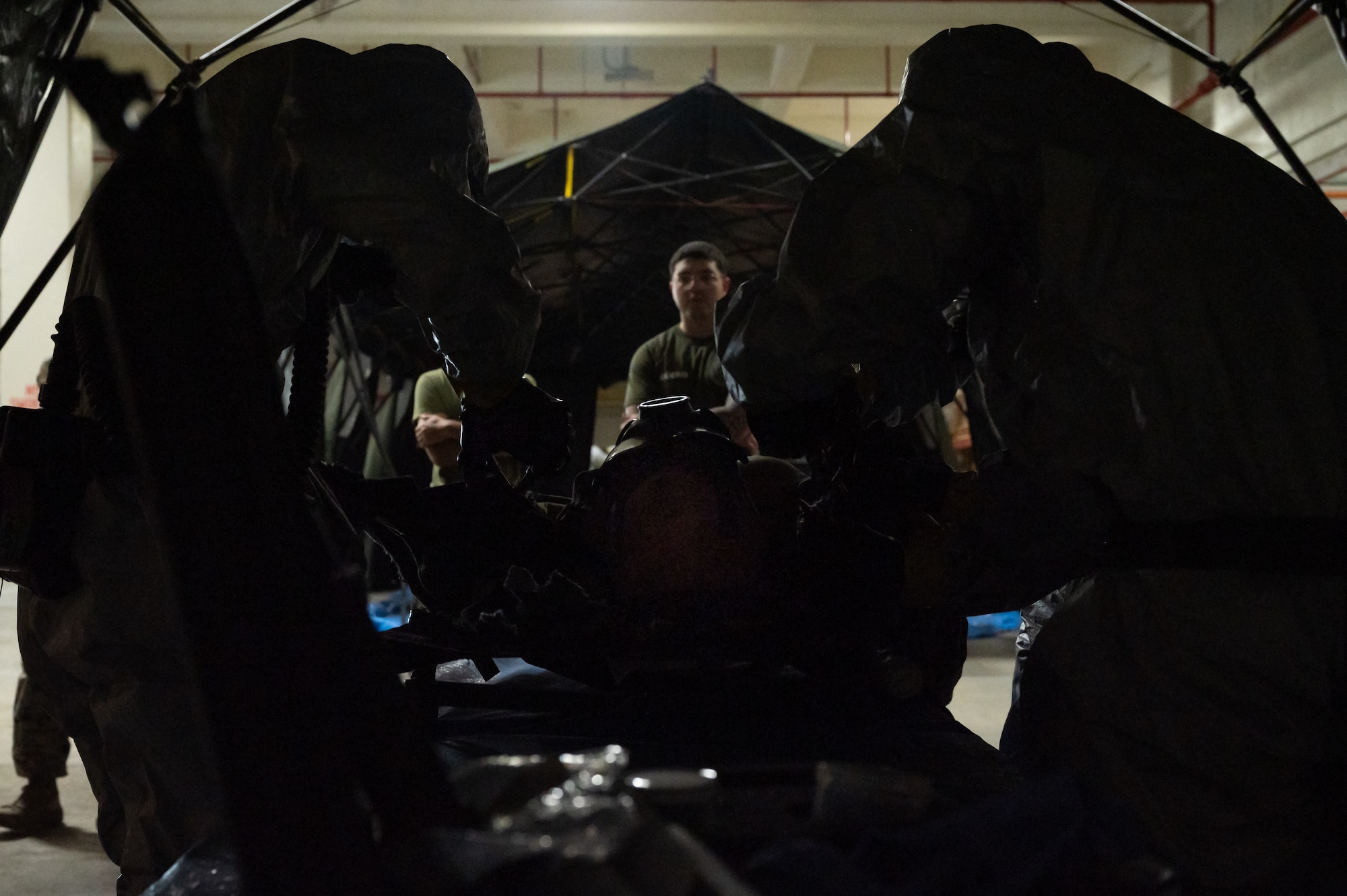 Marines decontaminate a training dummy.