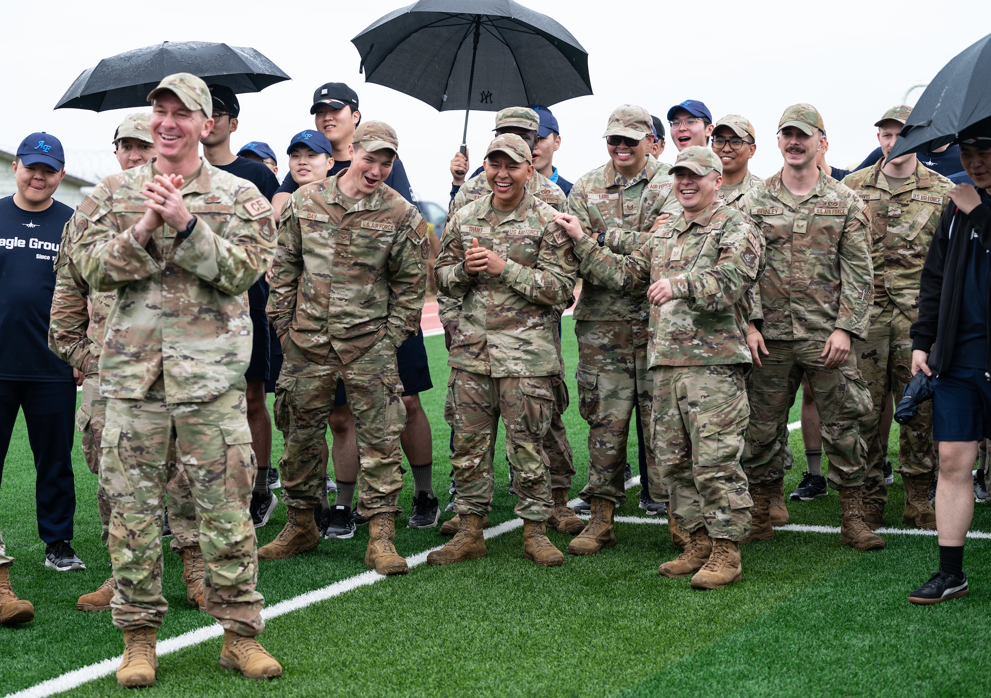 personnel cheer on team members as they complete an obstacle at Kunsan Air Base