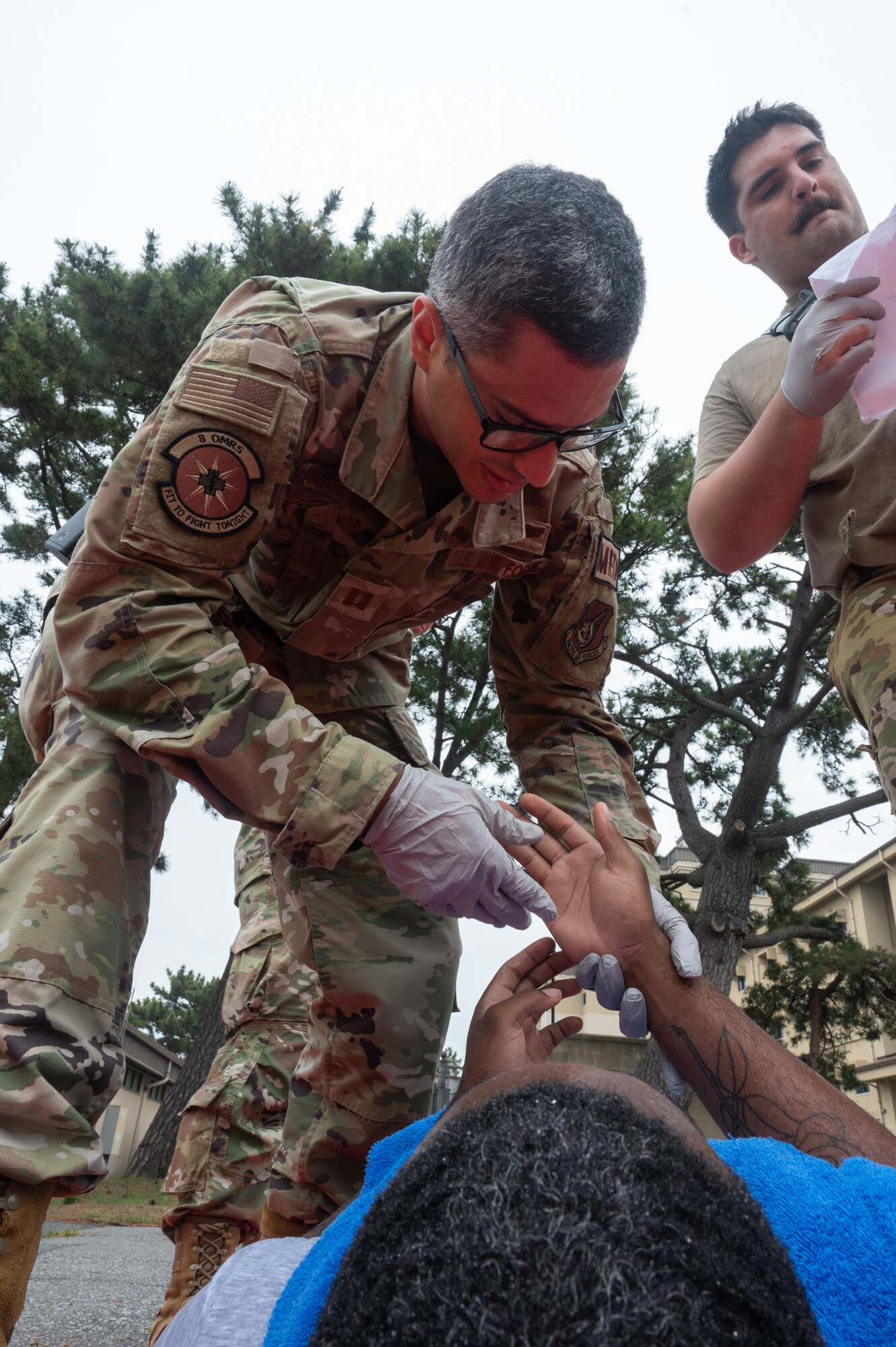 8th Operational Medical Readiness Squadron Aerospace Medical Flight commander, triages a simulated patient’s hand injury during a mass casualty training event at Kunsan Air Base