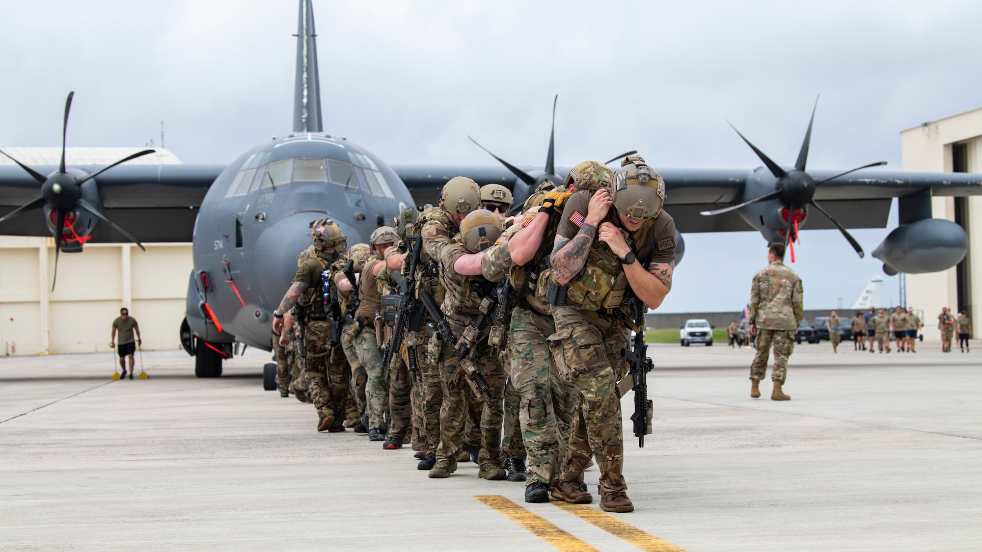 U.S. Air Force special tactics Airmen with the 320th Special Tactics Squadron pull an MC-130J Commando II 150 meters across the parking apron during Monster Mash, an operational readiness and resilience training.