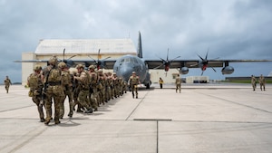U.S. Air Force special tactics Airmen with the 320th Special Tactics Squadron pull an MC-130J Commando II 150 meters across the parking apron during Monster Mash, an operational readiness and resilience training, at Kadena Air Base, Japan, May 5, 2023. The Airmen were presented with multiple tasks throughout the seven mile route, including a humvee push, litter carries and fast rope insertions, all while wearing a full ensemble of body armor, weapons and equipment. (U.S. Air Force photo by Staff Sgt. Jessi Roth)