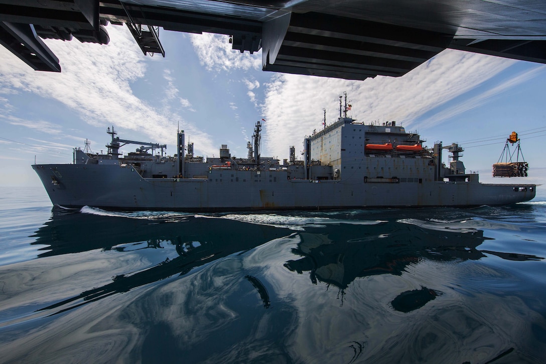 A ship performs a replenishment at sea.