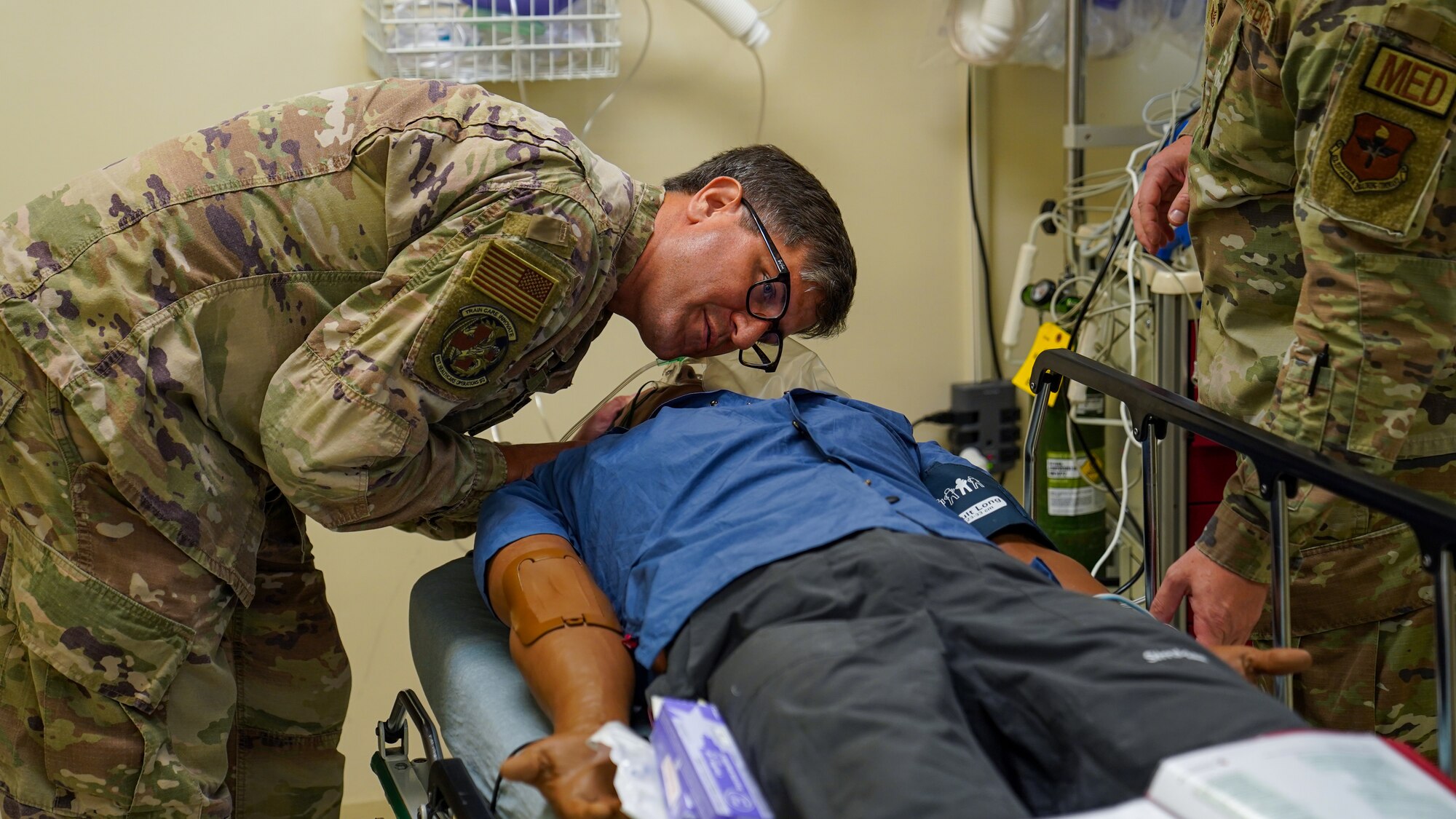 U.S. Air Force Lt. Col. Blake Elkins, 81st Healthcare Operations Squadron endocrinologist, checks a training mannequin for breathing sounds in the Advanced Life Support Course in the simulation lab at the Keesler Medical Center on Keesler Air Force Base, Mississippi, May 17, 2023.