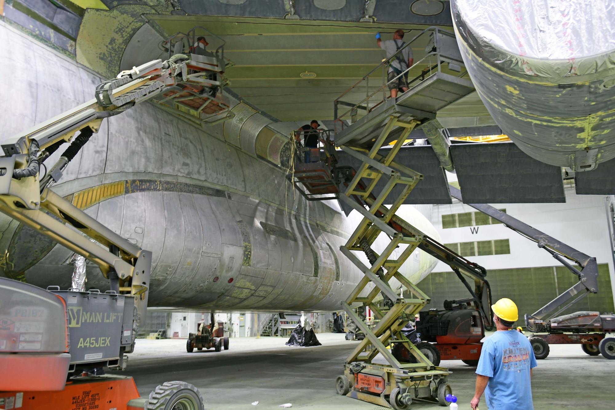 painters preparing aircraft for painting